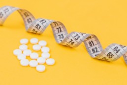 white round medication pill on yellow surface